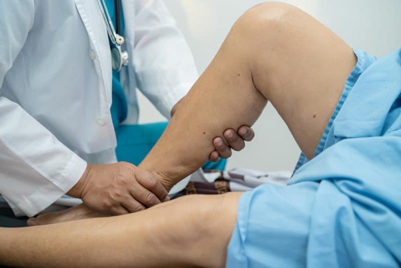 asian-doctor-physiotherapist-examining-massaging-treatment-knee-leg-senior-patient-orthopedist-medical-clinic-nurse-hospital (1)