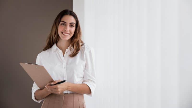 front-view-elegant-businesswoman-holding-clipboard-with-copy-space
