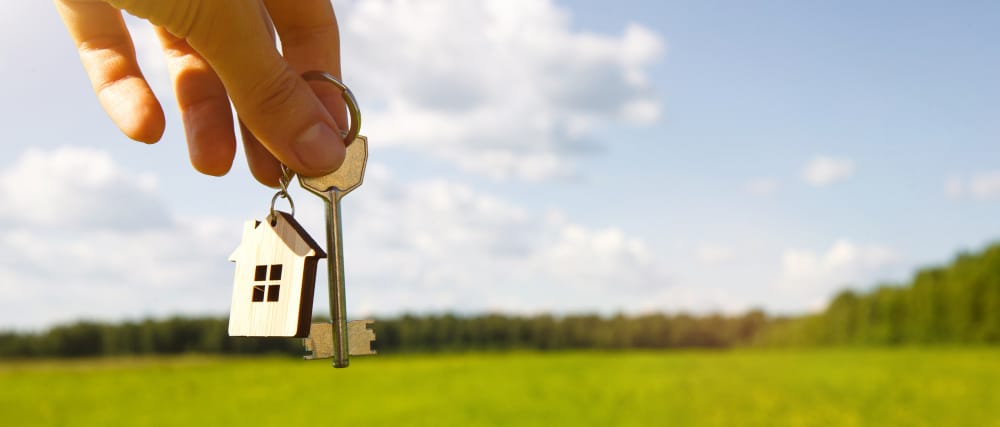 key-wooden-keychain-shape-house-hand-field